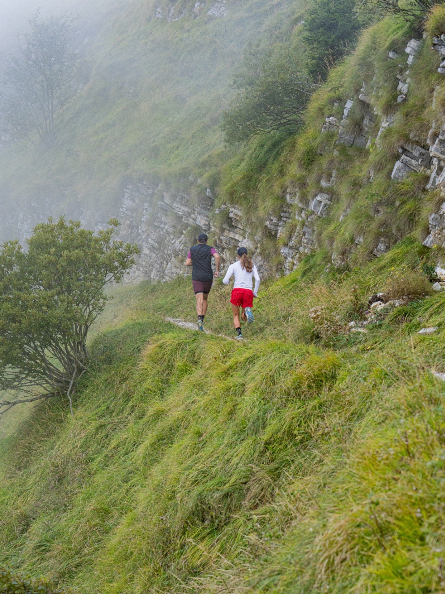 male and female runners climbing an Italian mountain