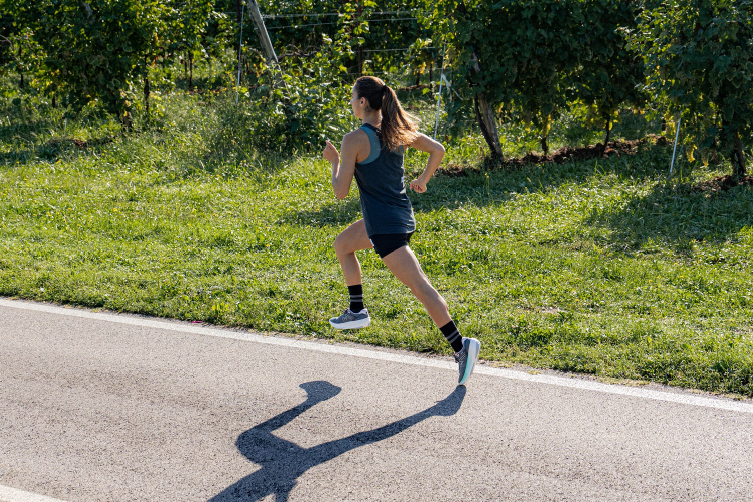 Female athlete running with powerful stride in KARHU women's Fusion 4.0 running shoe